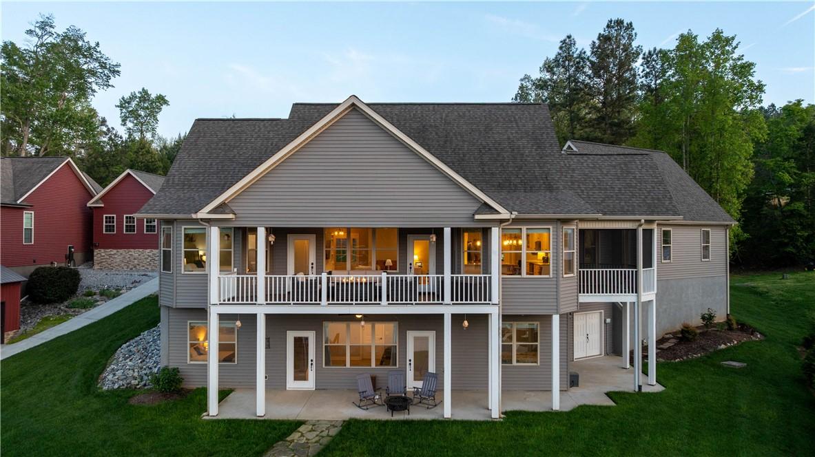 Image 1: This spacious home boasts expansive decks and pati