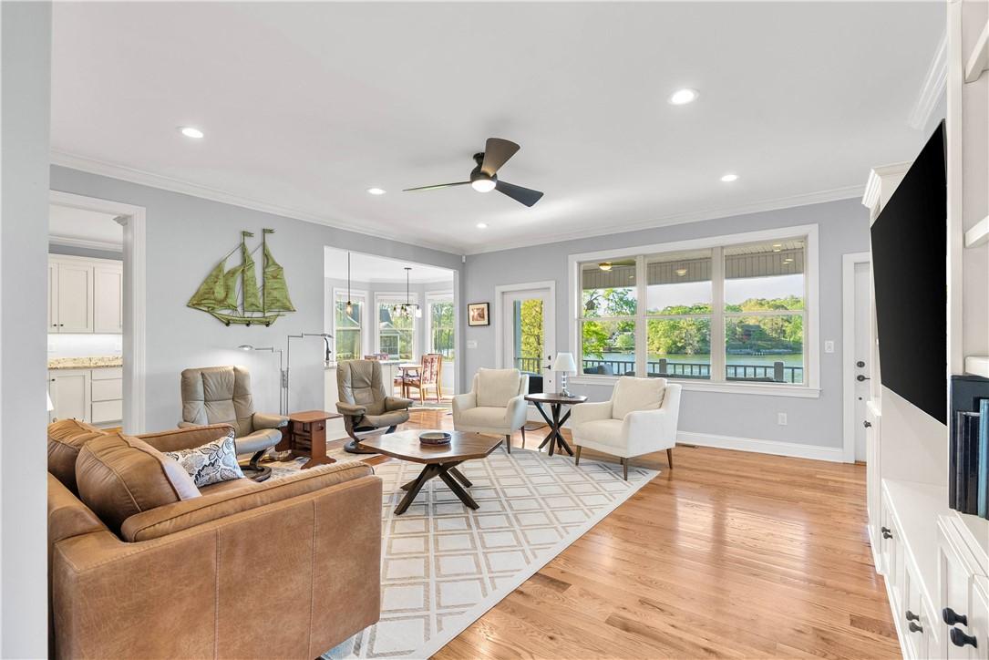 Image 2: This bright living space features hardwood floors,