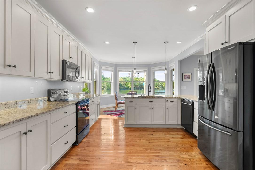Image 3: This kitchen features a bright ambiance, with a ca