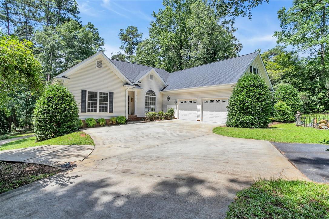 Image 3: A classic ranch home features an attached garage a
