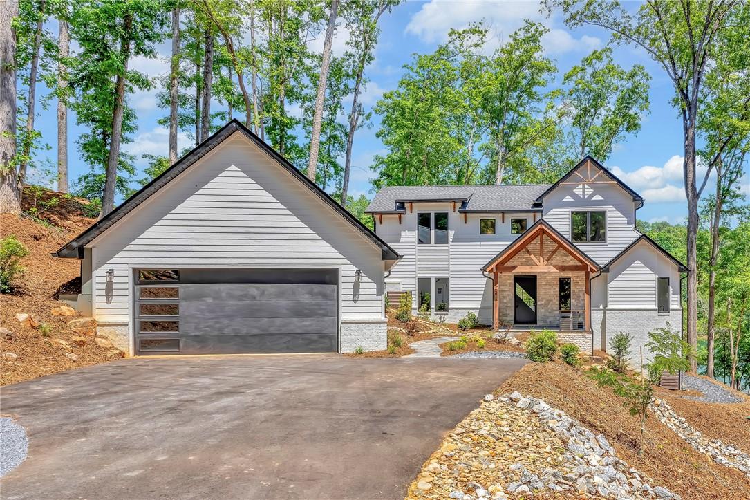 Image 1: Modern craftsman-style residence with a striking s