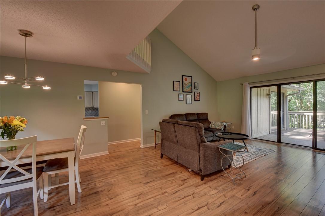 Image 3: A spacious living area with vaulted ceilings and g