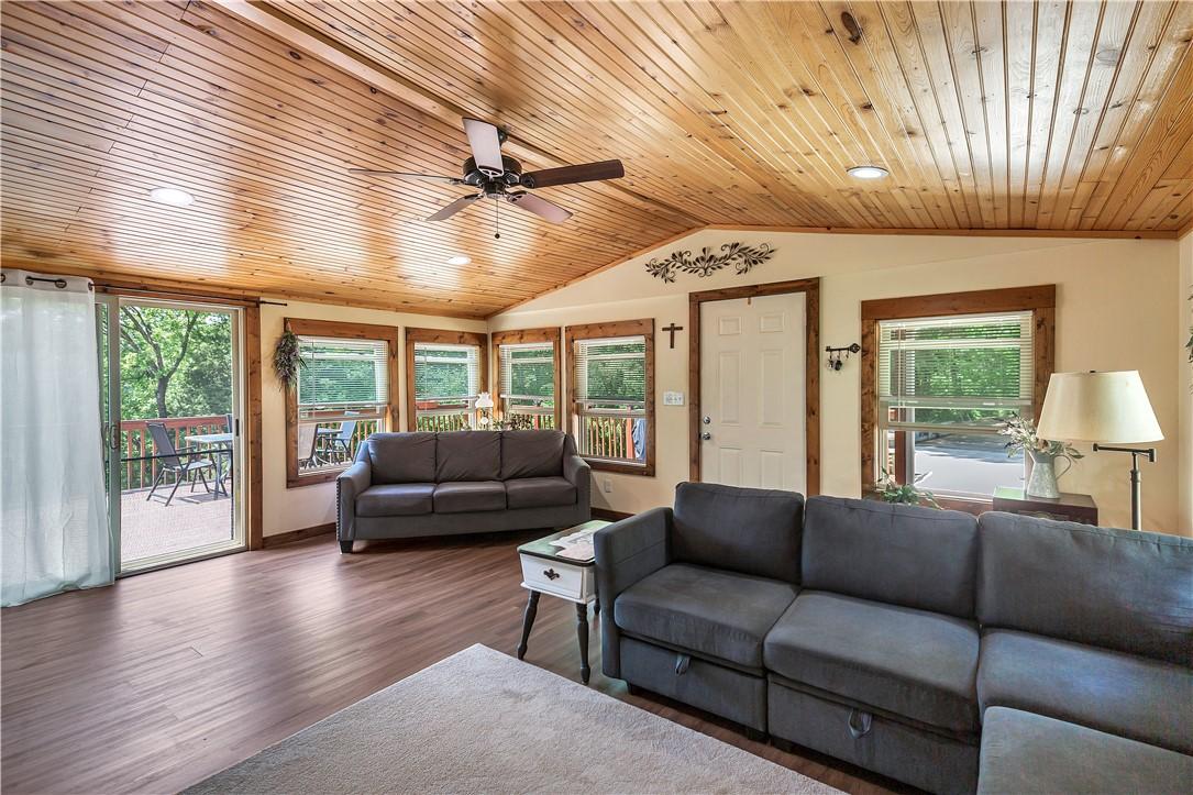 Image 2: This inviting living space features warm wood plan