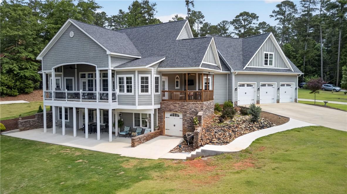 Image 2: A spacious home with multiple garage doors and an