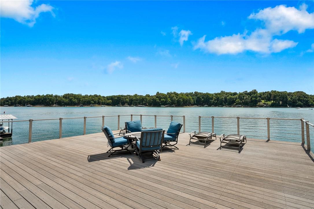 Image 3: An expansive lakeside deck provides a serene outdo