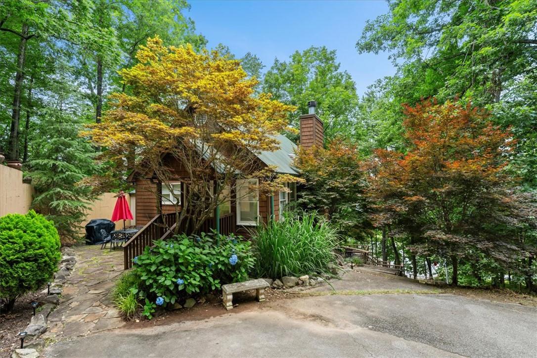 Image 2: A charming rustic cabin nestled among verdant foli