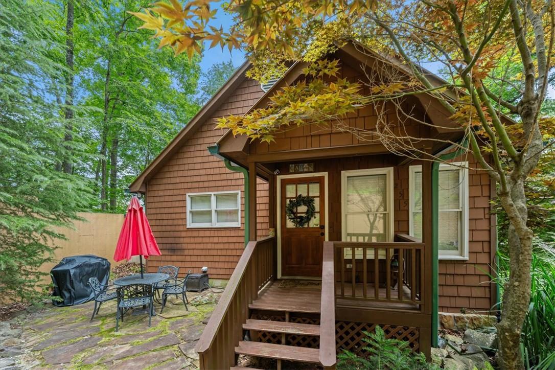 Image 3: A welcoming front porch leads to this charming cot