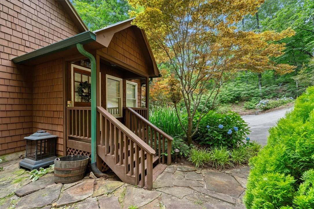 Image 4: A charming cabin entryway invites with natural woo