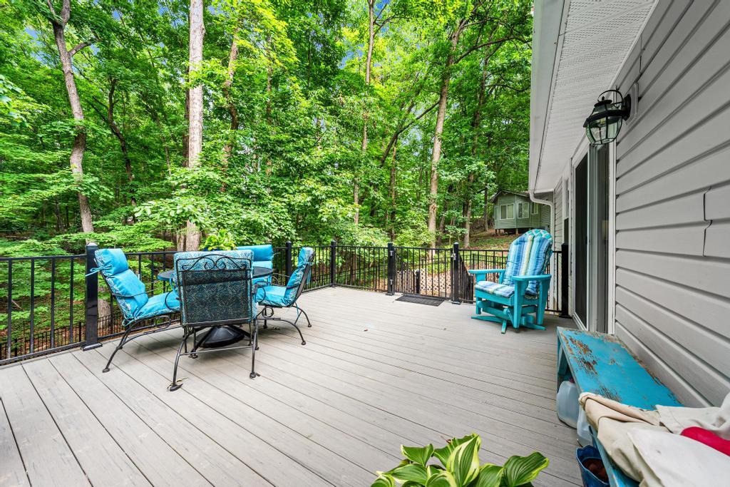 Image 4: A spacious outdoor deck with serene forest views o