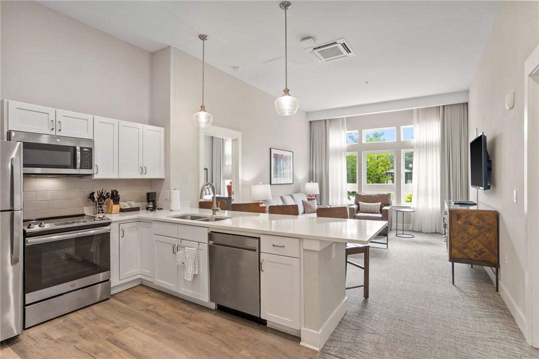 Image 3: An open-concept living area with abundant natural