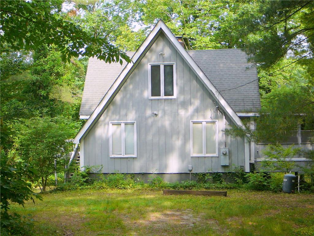 Image 4: A-frame design nestled amidst abundant greenery of