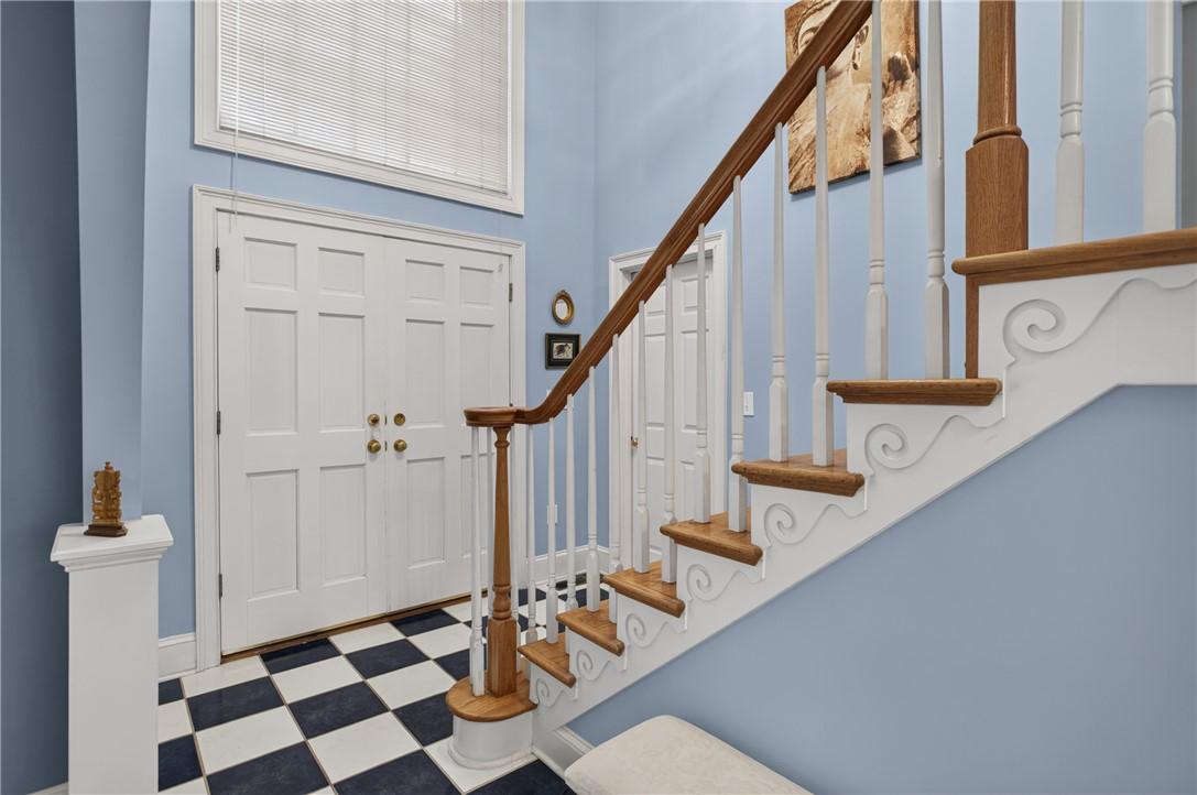 Image 2: A grand entrance with checkerboard flooring and an