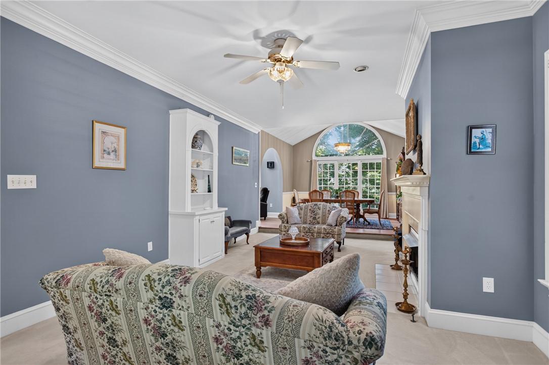 Image 4: A graceful fireplace anchors this living space, of