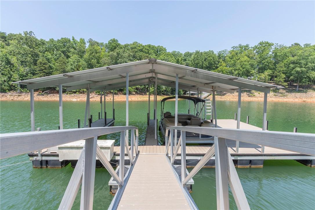 Image 4: Boathouse with a walkway leading to the calm lake,