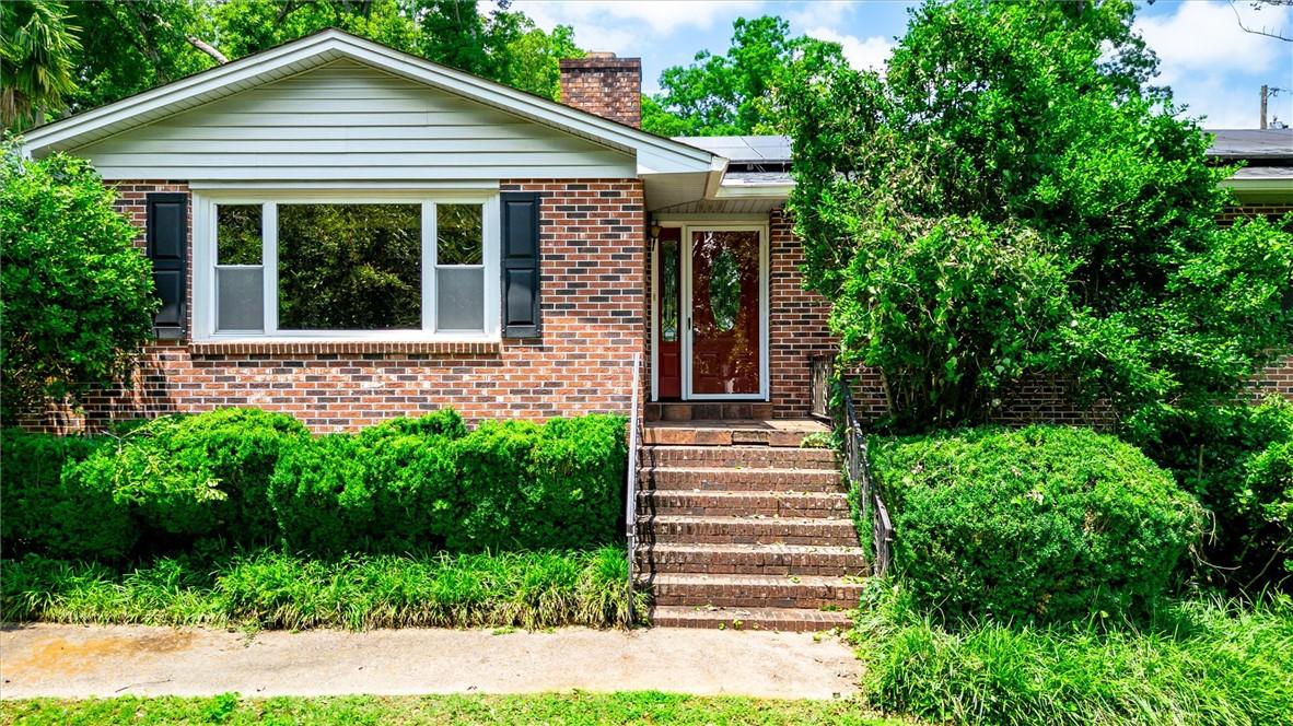 Image 4: A charming brick exterior with a welcoming entrywa