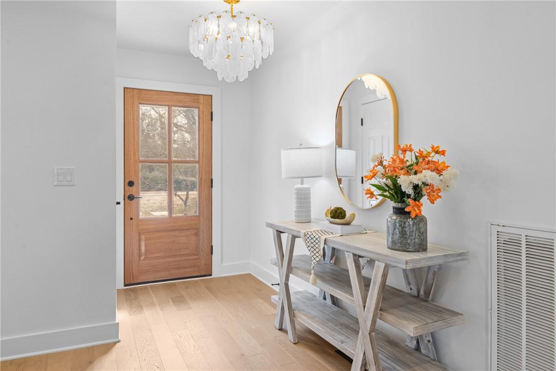 Image 3: This bright and inviting entryway features a beaut