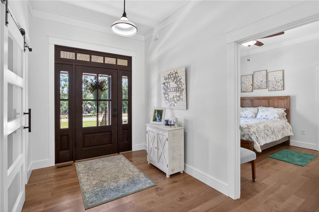 Image 4: Enter through a warm, glazed entry door with sidel