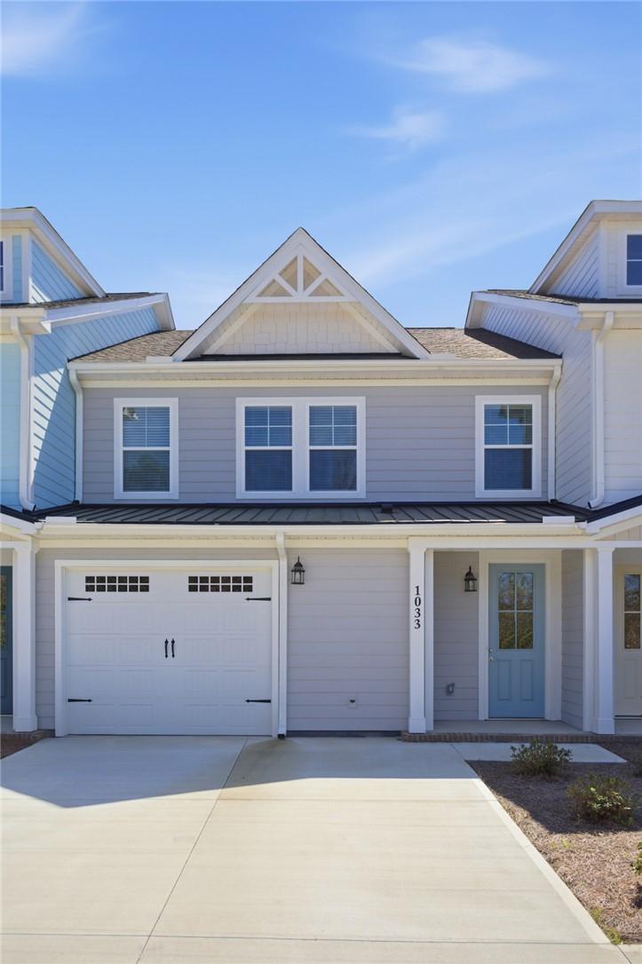 Image 1: This inviting home presents a charming exterior wi