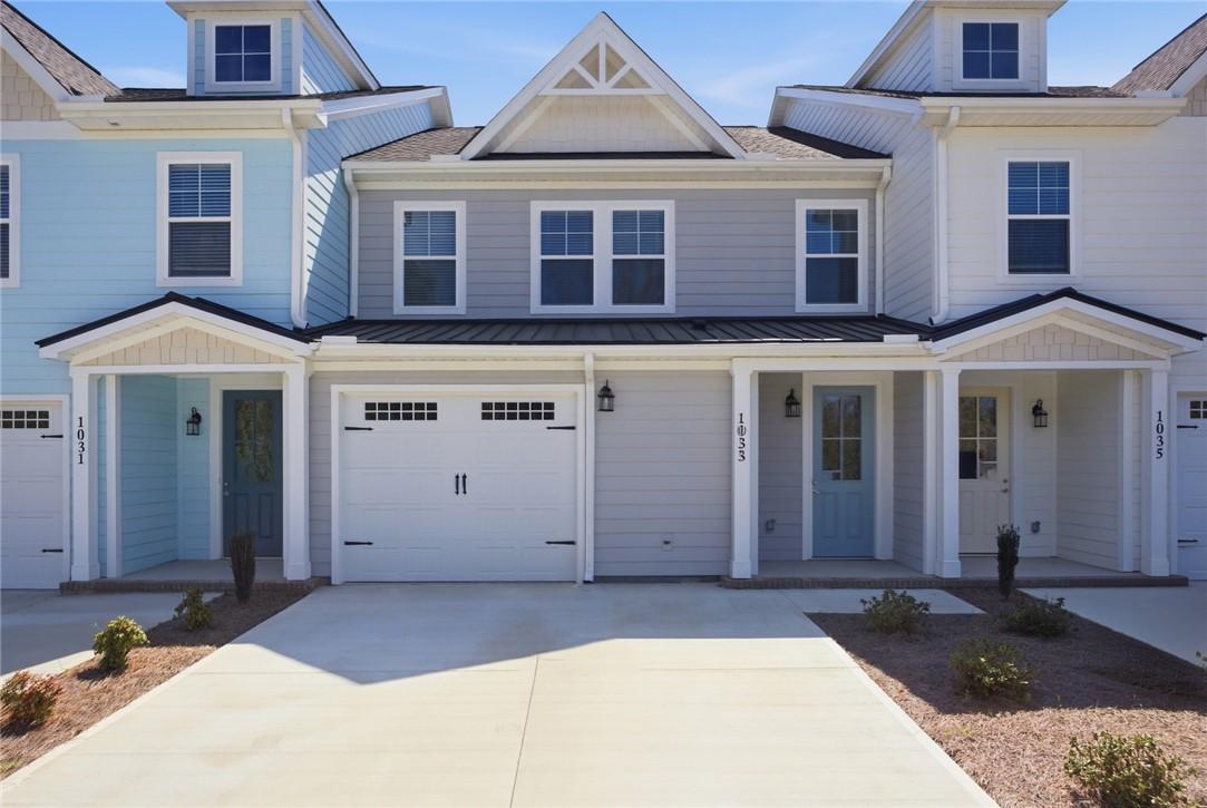 Image 2: These charming townhomes feature durable siding an