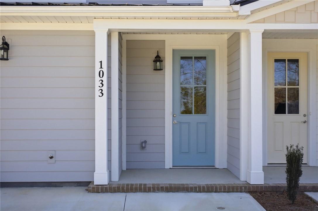 Image 3: This charming entrance features a welcoming blue d