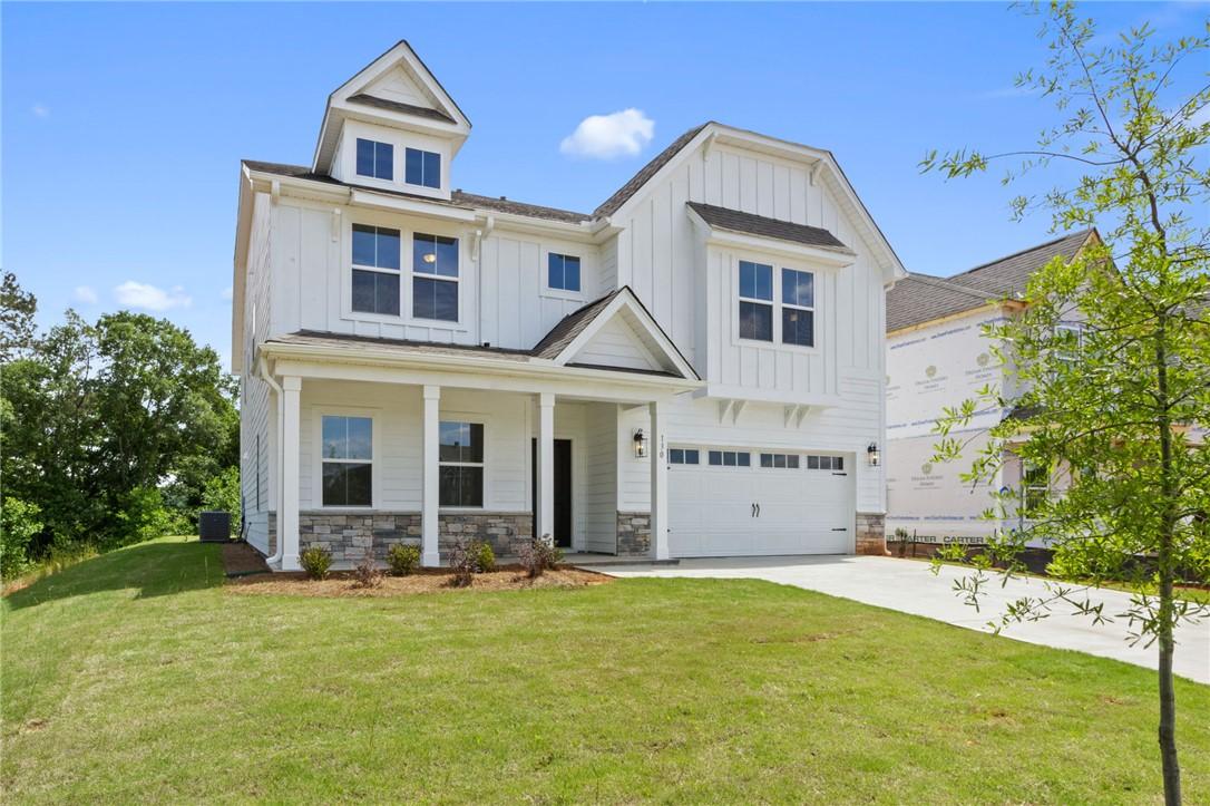 Image 2: White siding and stone accents adorn this charming