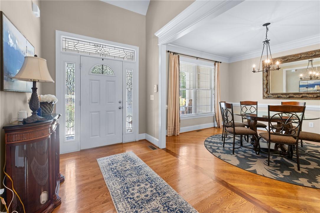 Image 3: A welcoming entryway with lustrous hardwood floori