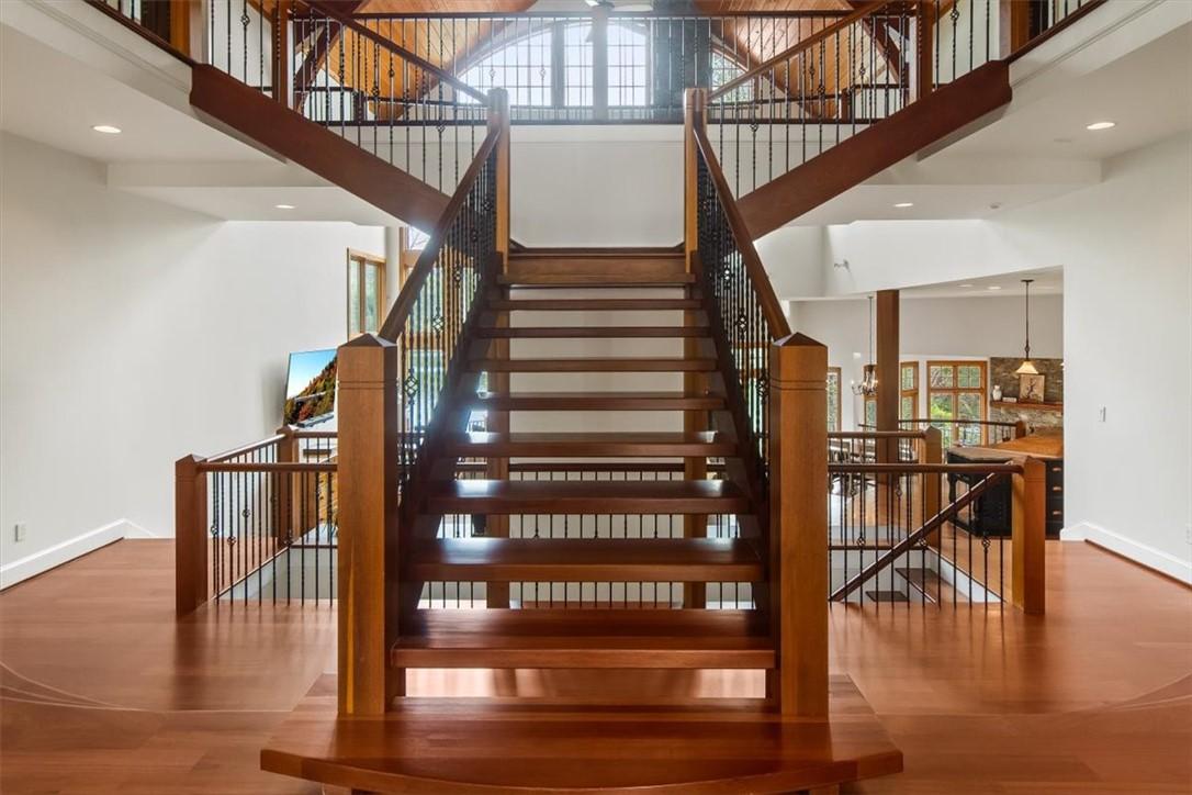 Image 3: This grand foyer showcases an impressive split sta