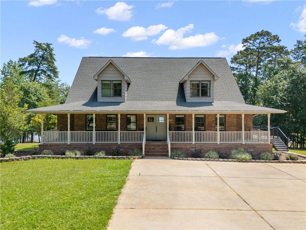 Image 1: A charming brick residence awaits, featuring a wel