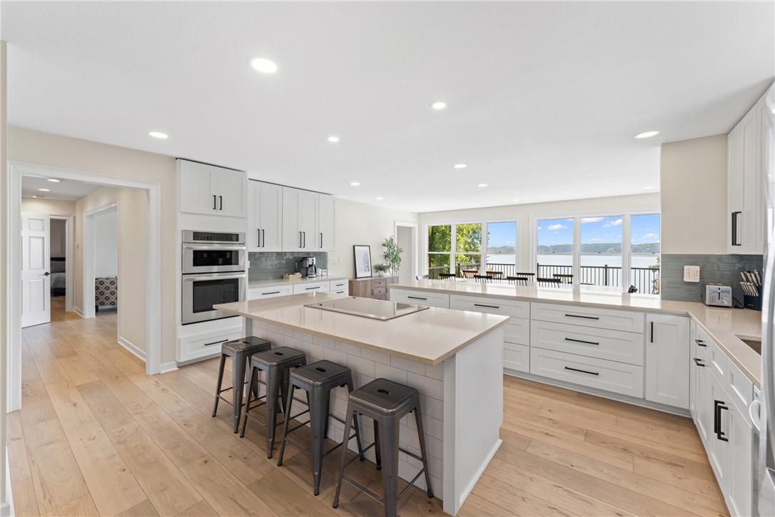 Image 3: A chef's dream kitchen offers a spacious island, b