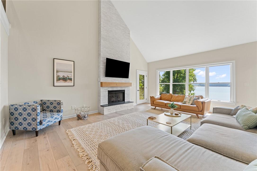 Image 4: A spacious living area features high vaulted ceili