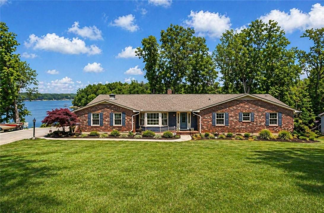 Image 1: This charming brick home offers picturesque waterf