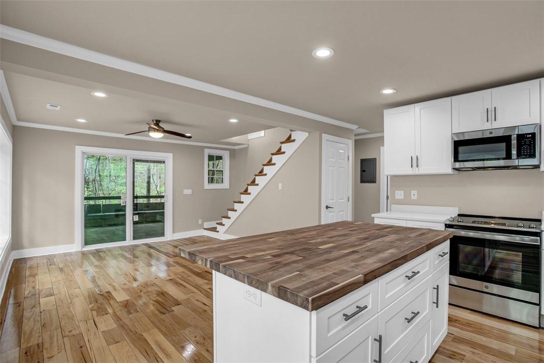 Image 4: Hardwood floors and sleek appliances elevate this