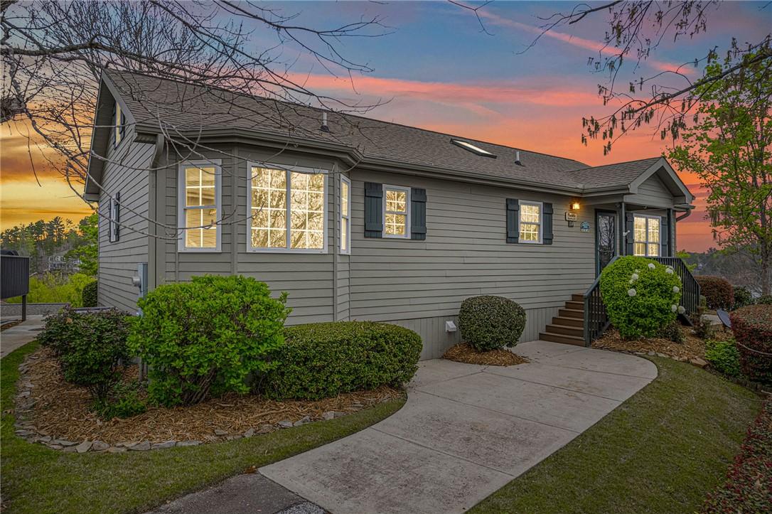 Image 2: An inviting exterior with ample greenery awaits, b