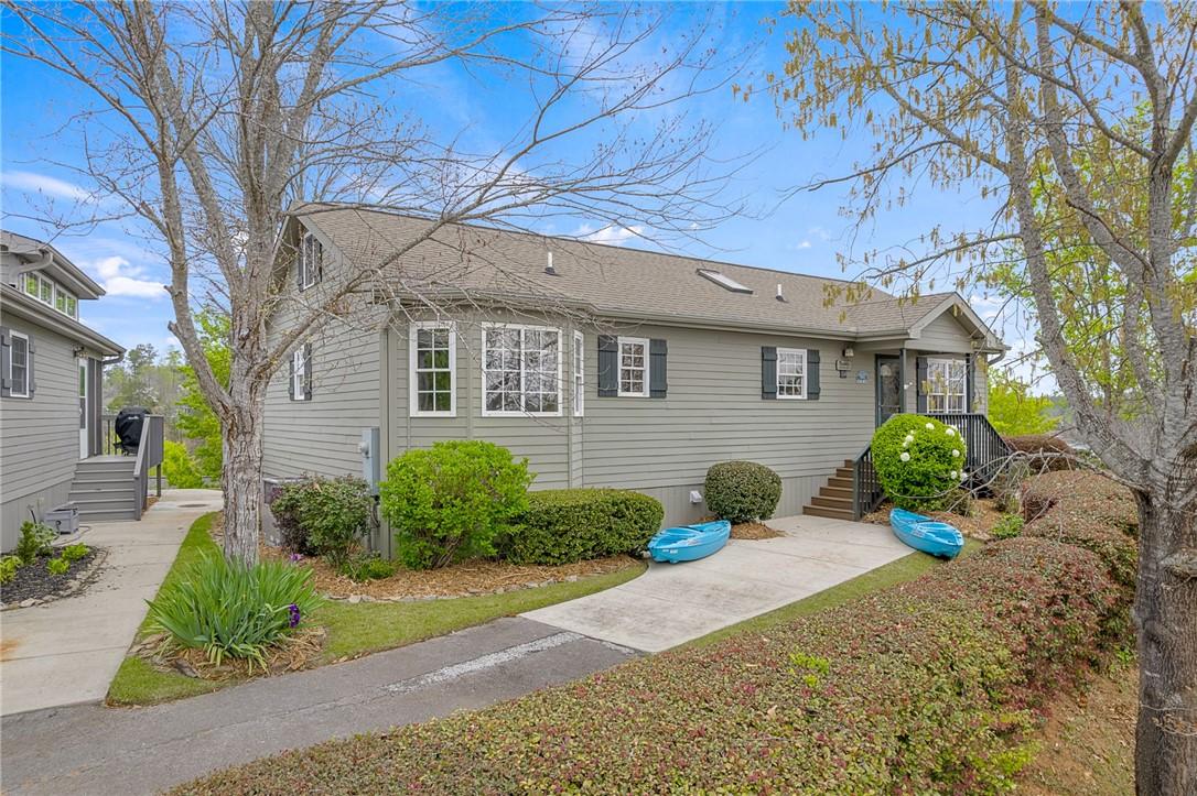 Image 3: This charming home offers curb appeal and a serene