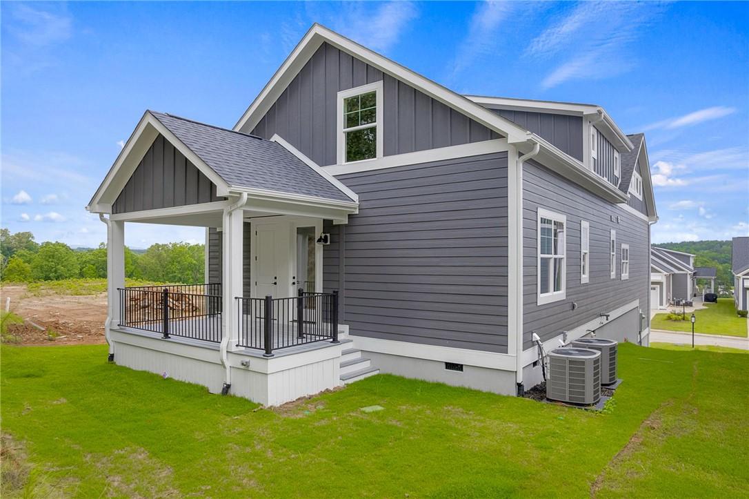 Image 2: A striking gray facade with crisp white trim and a
