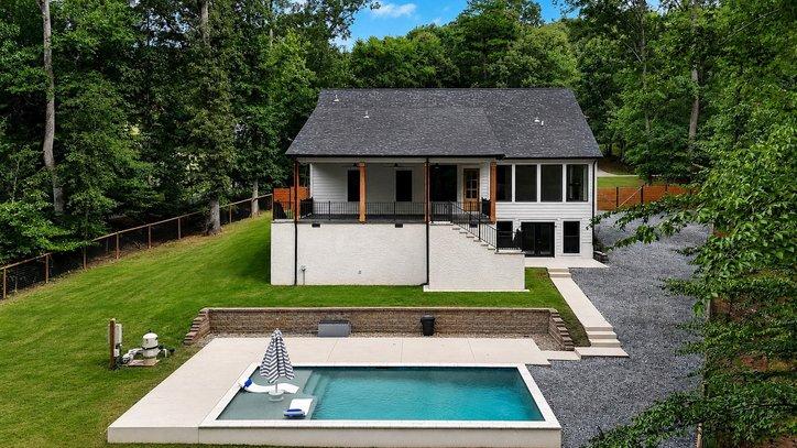 Image 3: Backyard oasis with a refreshing pool, expansive p