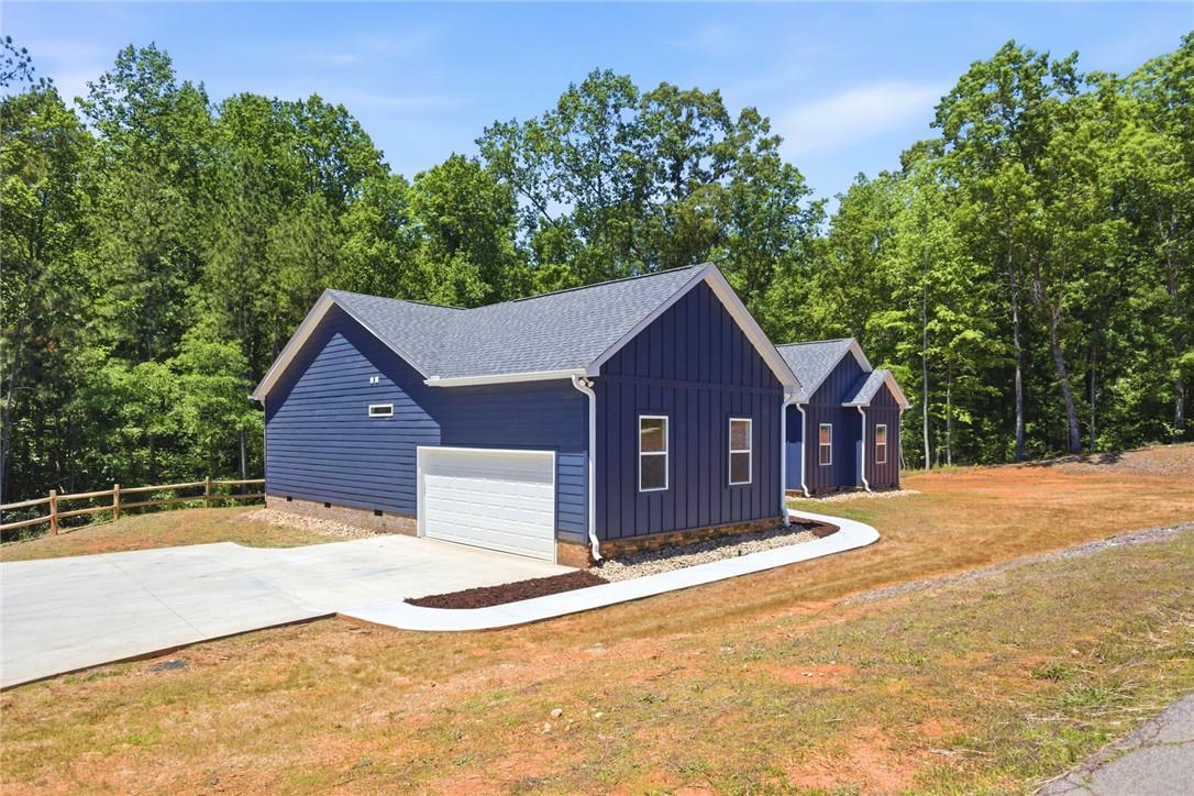 Image 4: This modern home features striking blue siding, a