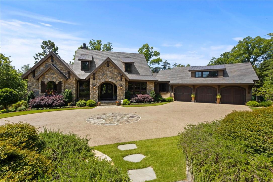 Image 1: A grand stone facade welcomes you to this residenc