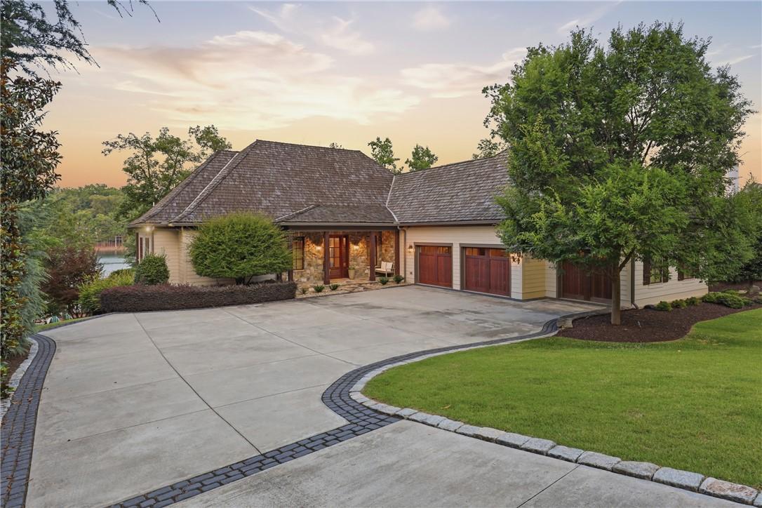 Image 1: A winding driveway leads to this charming home, ne