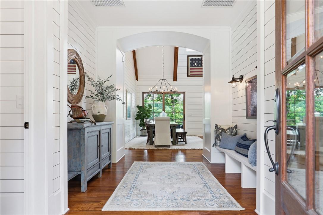 Image 2: A welcoming entry hall with hardwood flooring and