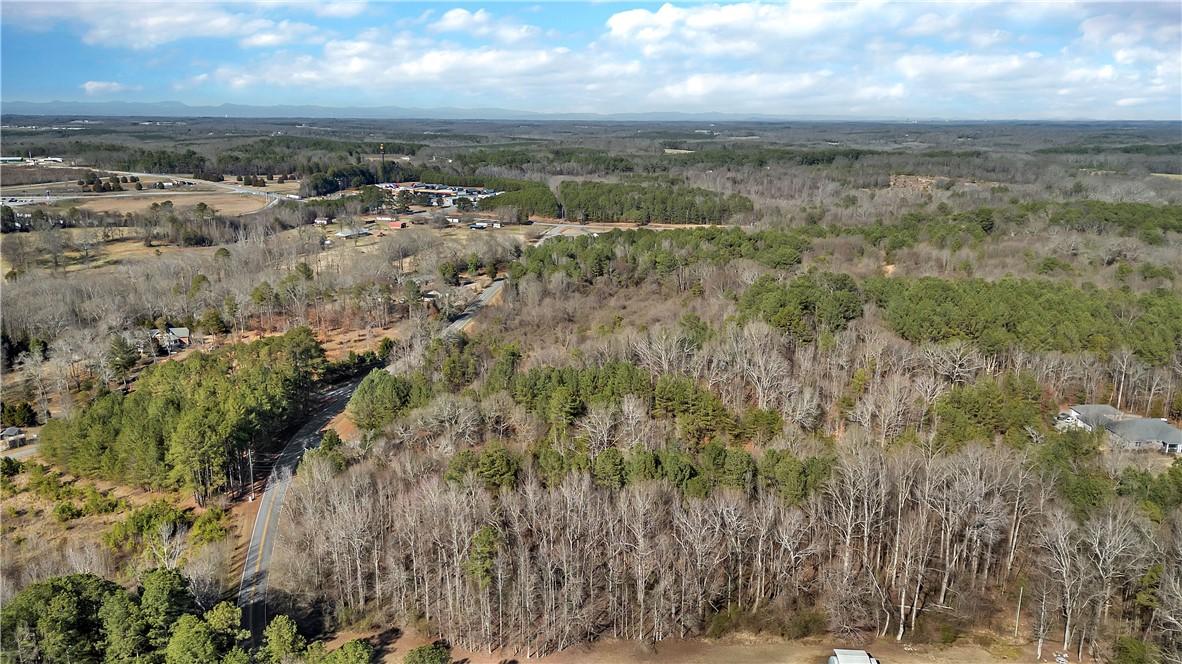 Image 4: This elevated view captures expansive wooded terra