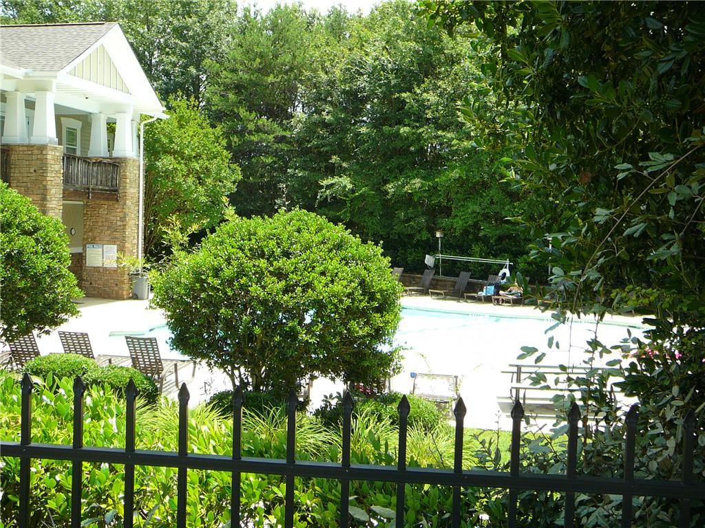 Image 4: A refreshing outdoor pool awaits, nestled beside a