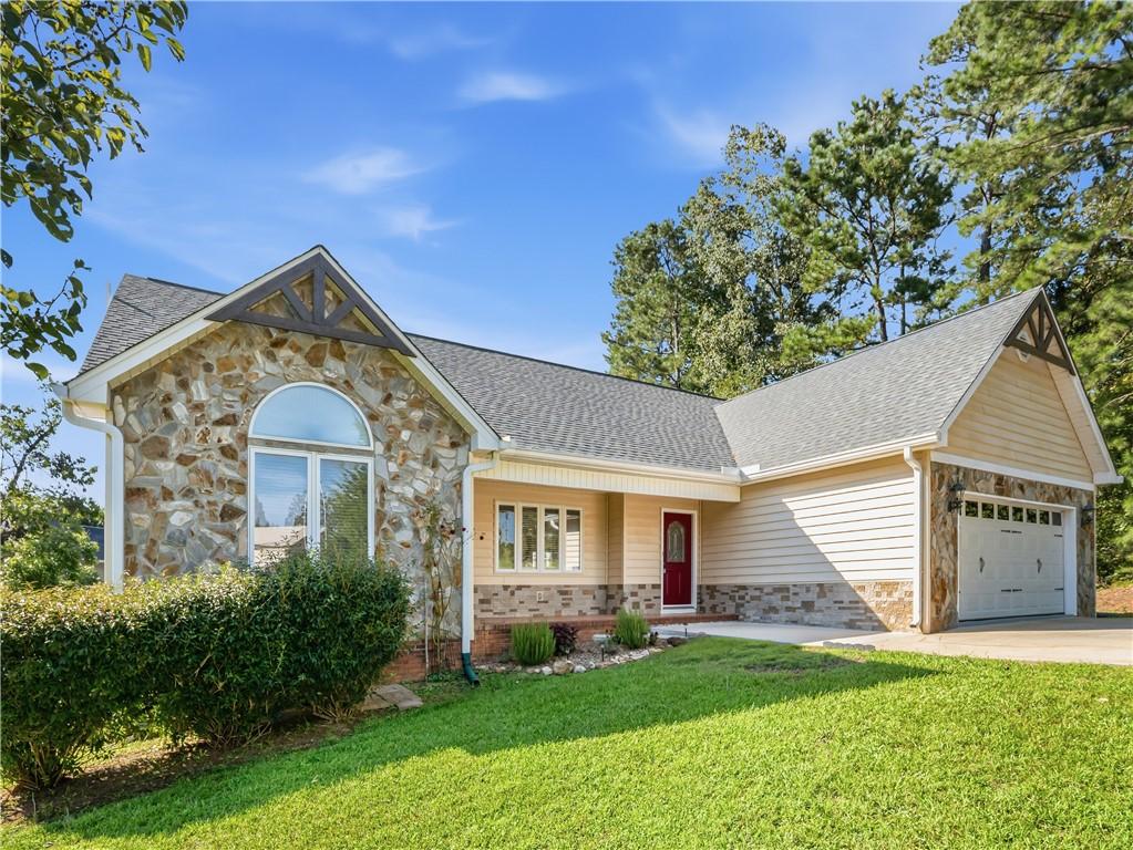 Image 2: This charming home offers a perfect blend of stone