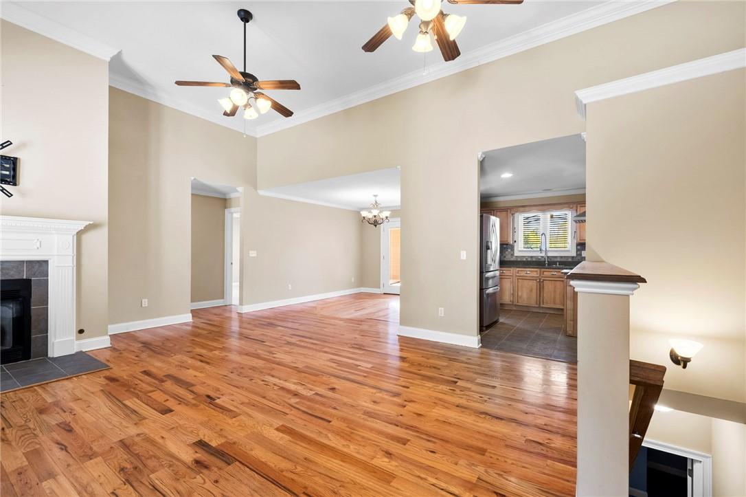 Image 4: This inviting space features lustrous hardwood flo