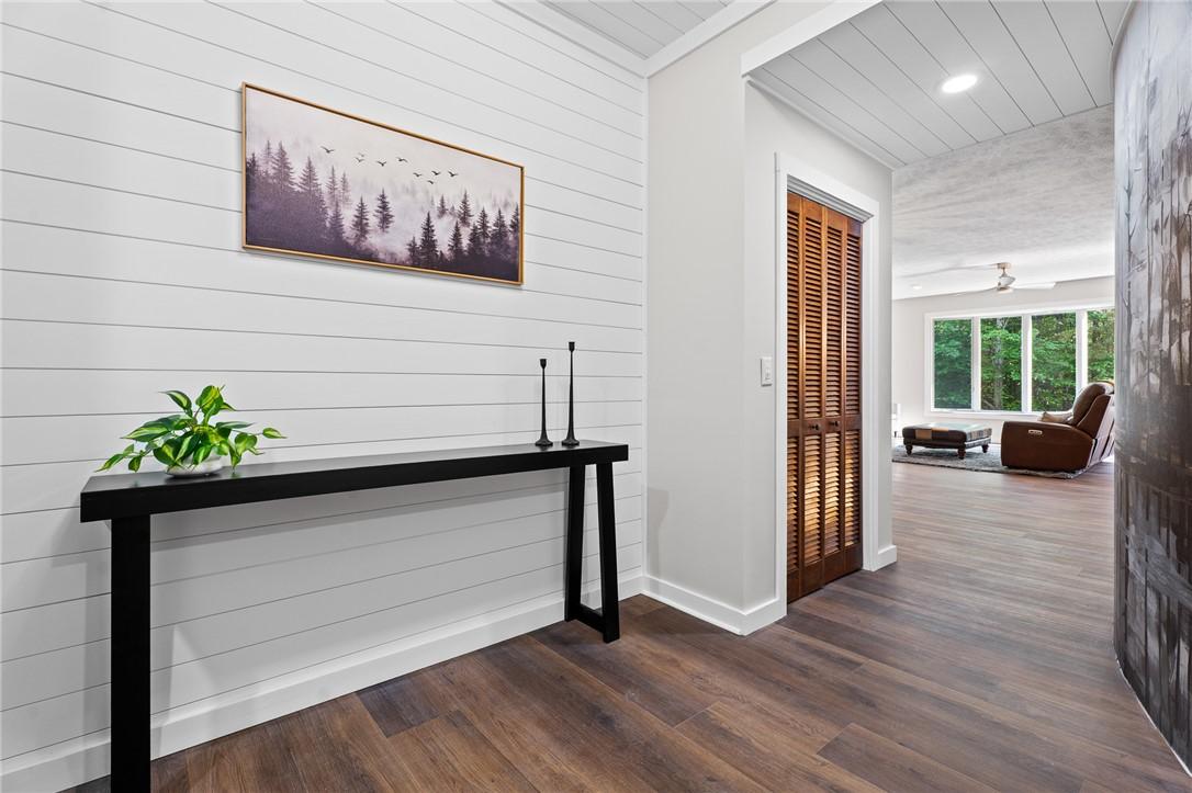 Image 3: This inviting entrance features rich hardwood floo