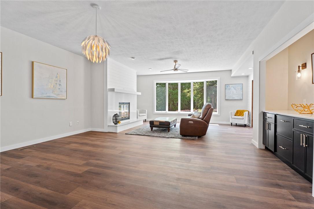 Image 4: This expansive living area offers warmth and moder
