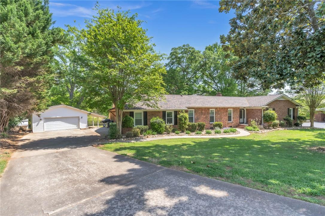 Image 2: This classic brick residence features an expansive