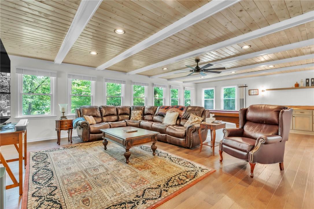 Image 3: This inviting living space features warm wood floo