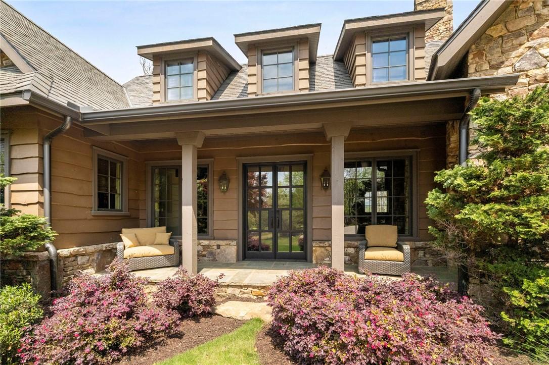 Image 4: This inviting home features a charming covered por