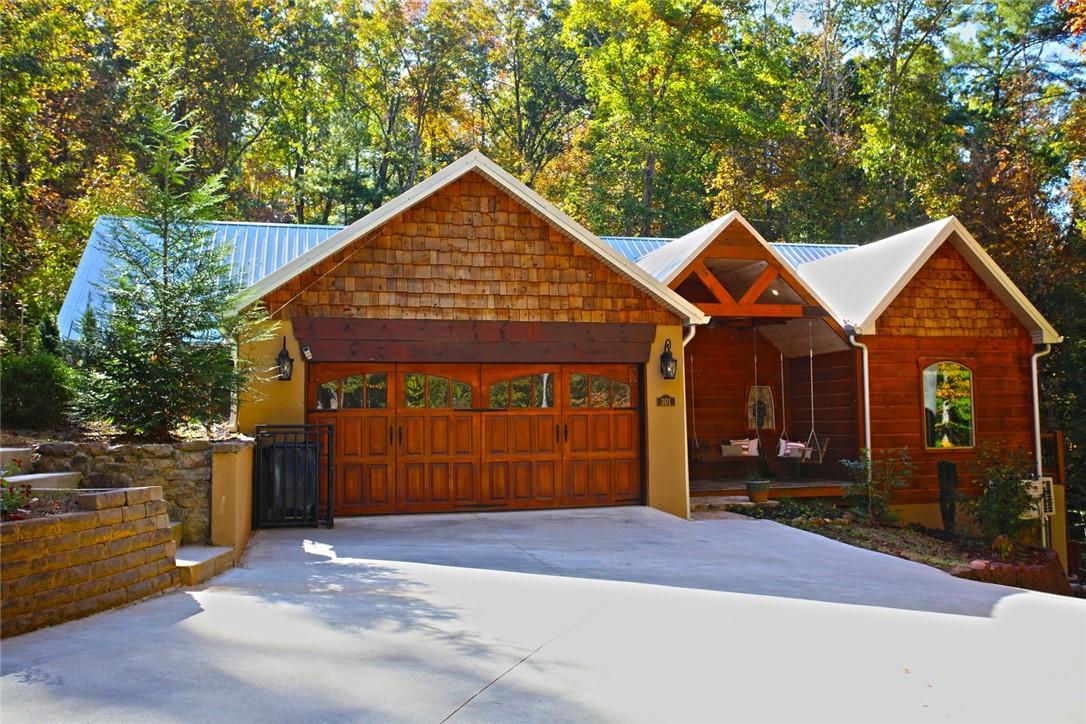 Image 1: This charming home offers a spacious garage and a
